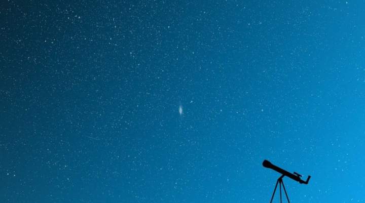 A telescope against a blue sky